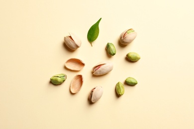 Photo of Composition with organic pistachio nuts on color background, flat lay