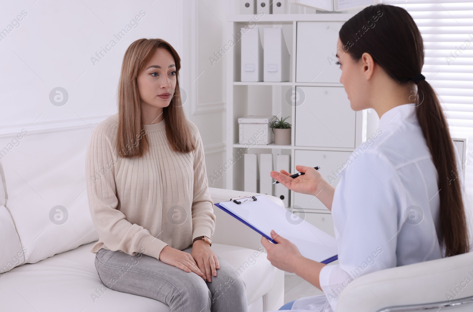 Photo of Young woman having appointment with STD specialist in clinic