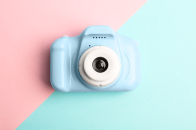 Photo of Light blue toy camera on color background, top view. Future photographer