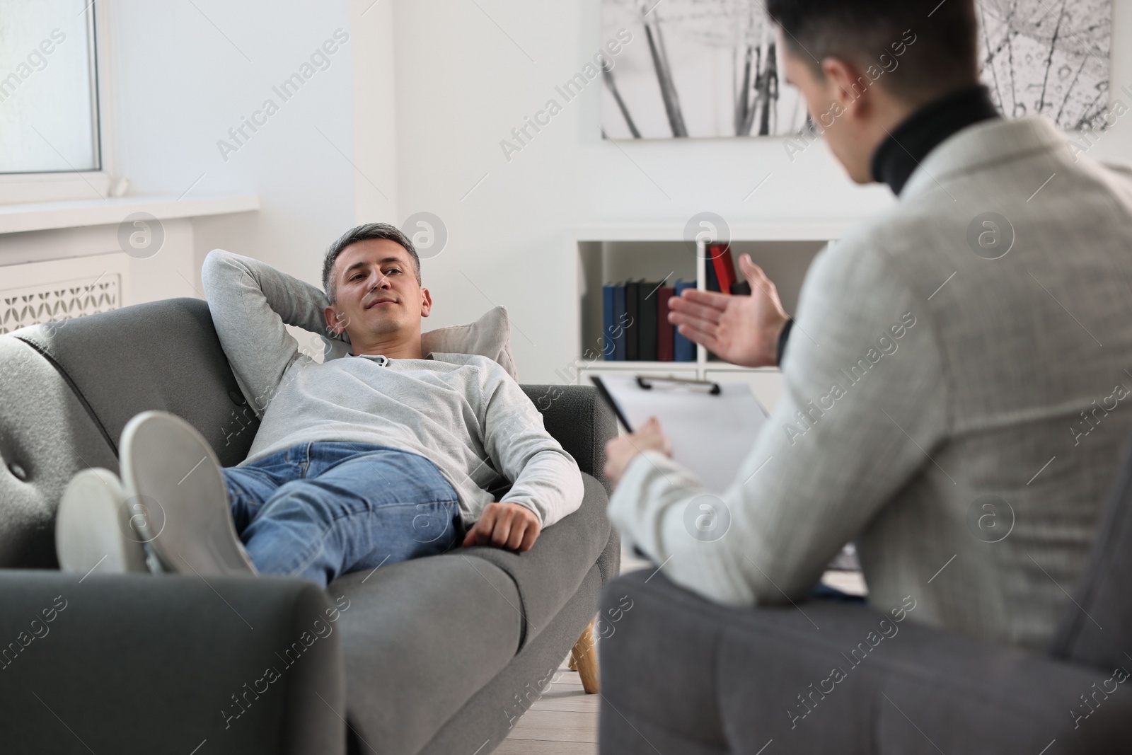 Photo of Professional psychotherapist working with patient in office