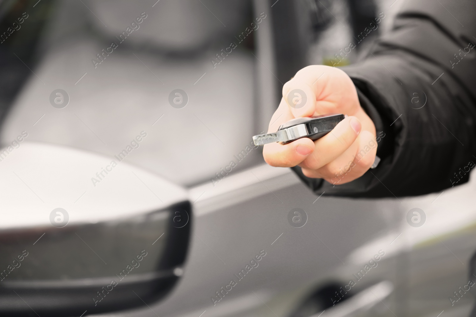 Photo of Closeup view of man opening car door with key