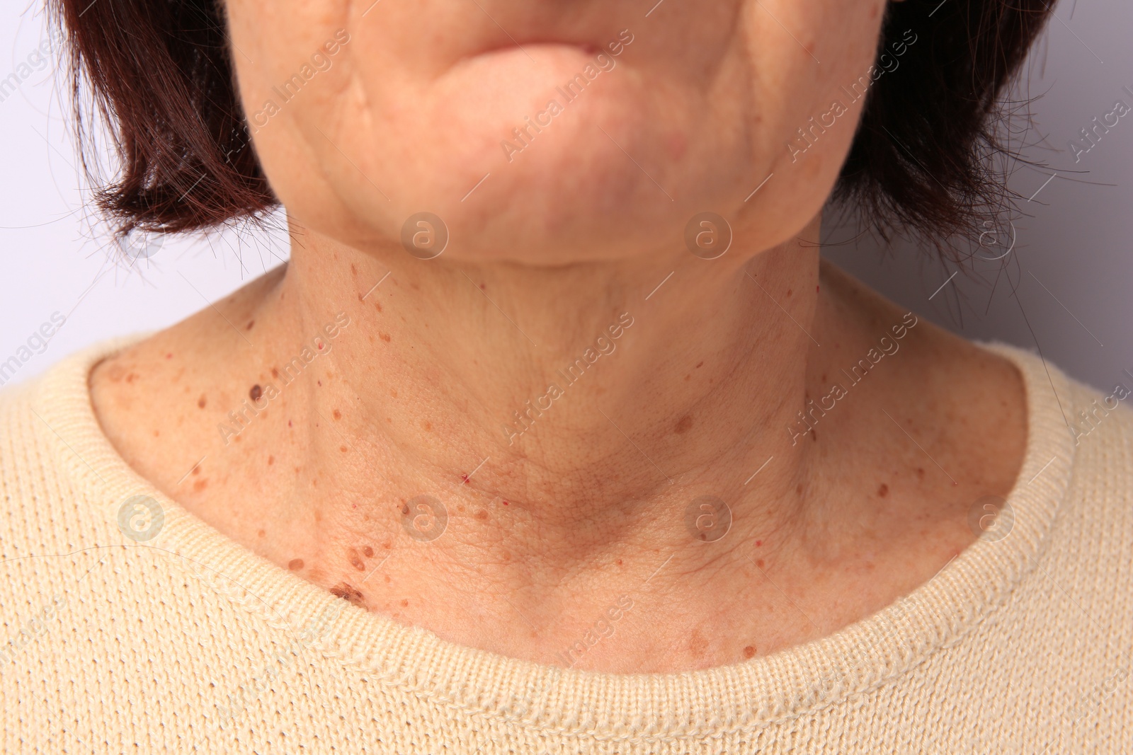 Photo of Closeup view of older woman on white background