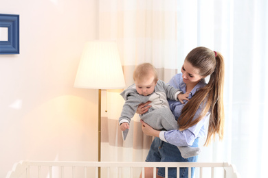 Teen nanny with cute little baby at home. Space for text
