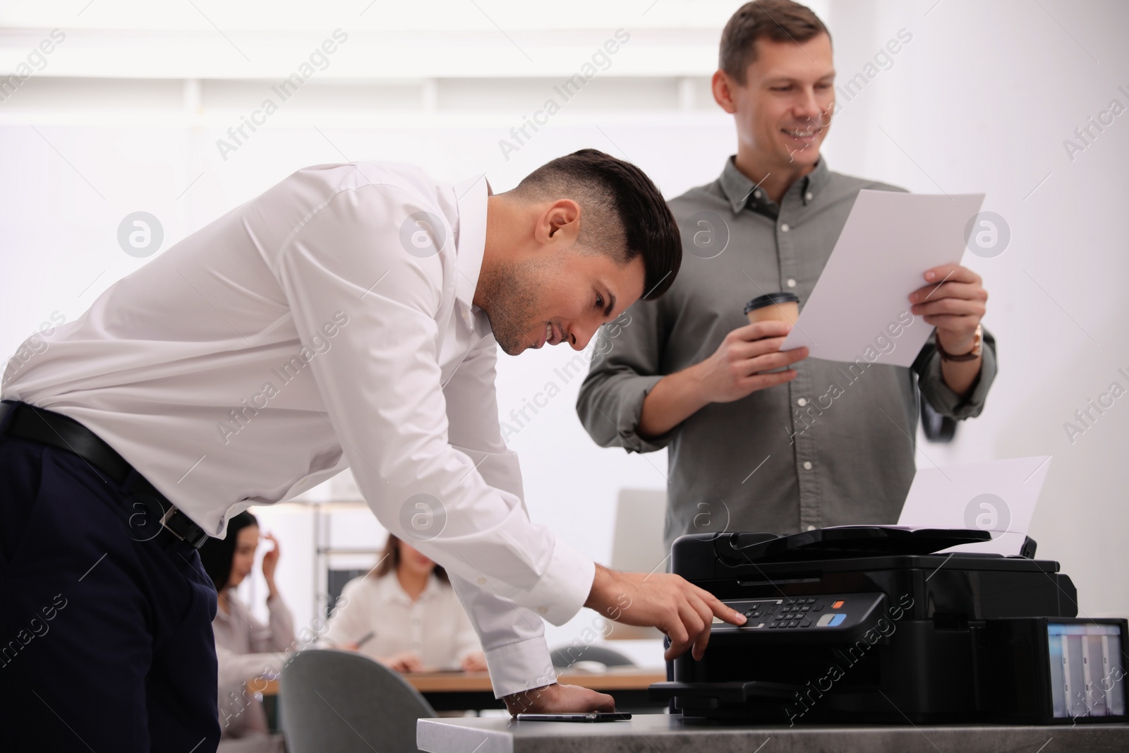 Photo of Employee using new modern printer in office