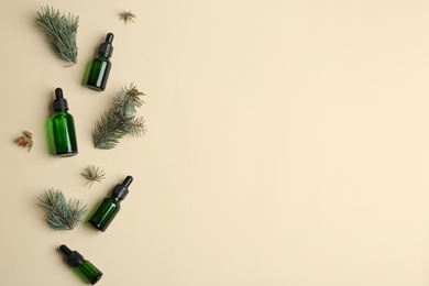 Flat lay composition with bottles of essential oil and space for text on color background