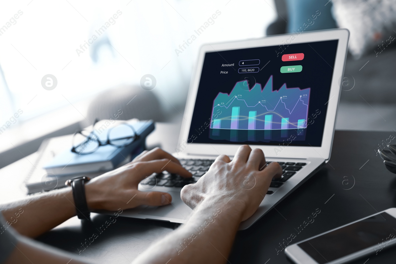 Image of  Broker working with laptop at table, closeup. Forex trading