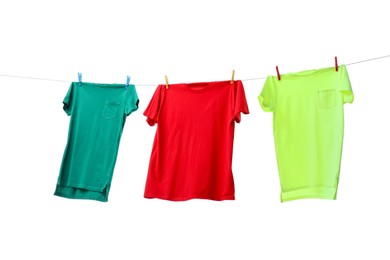 Colorful t-shirts drying on washing line isolated on white