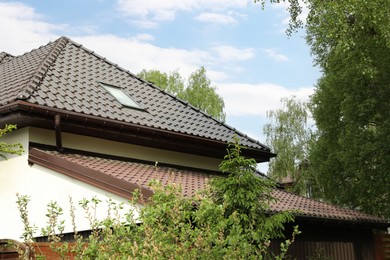 Photo of Modern building with grey roof outdoors on spring day