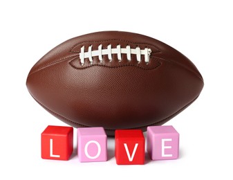 Photo of American football ball and cubes with word Love on white background