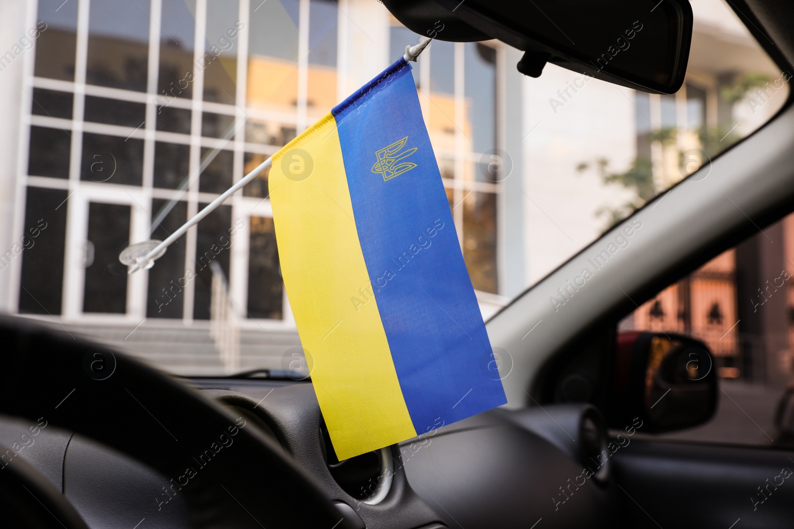 Photo of National flag of Ukraine on windshield inside car