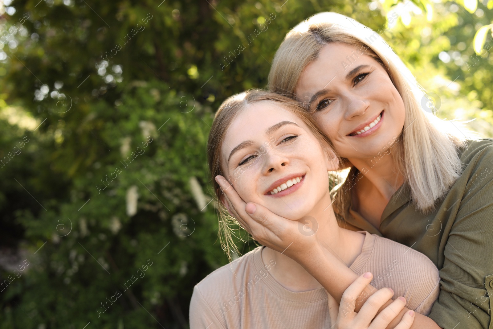 Photo of Happy mother with her daughter spending time together in park on sunny day