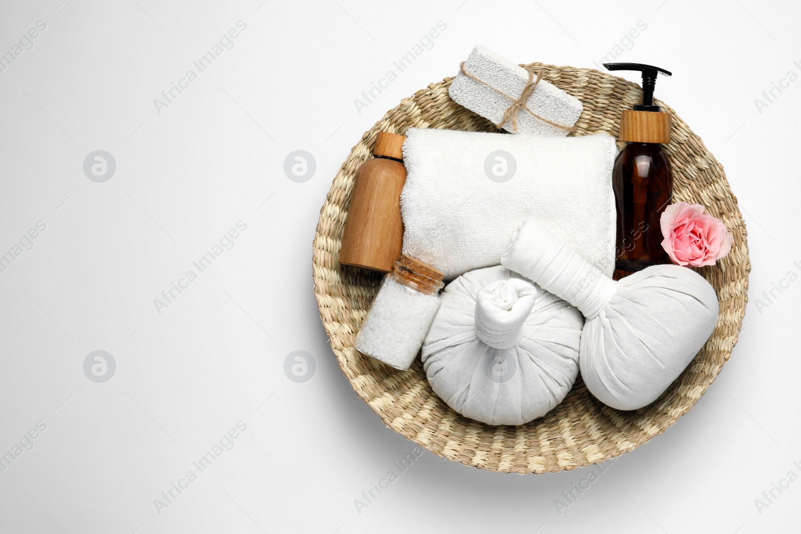 Photo of Beautiful spa composition with herbal massage bags and different care products on white background, top view. Space for text