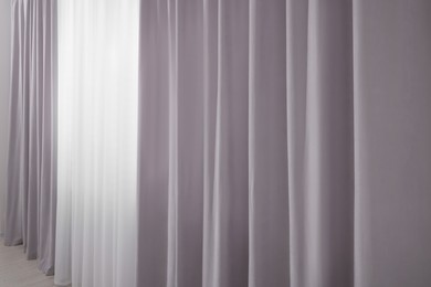 Light grey window curtains and white tulle indoors