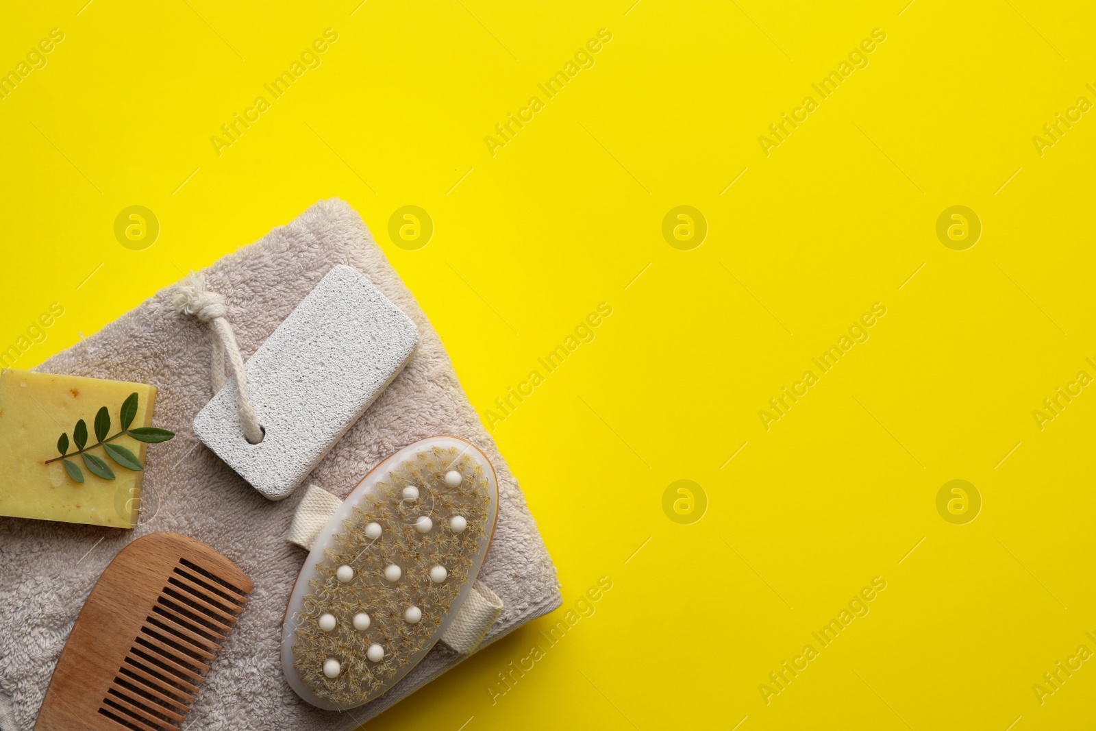 Photo of Flat lay composition with pumice stone on yellow background. Space for text