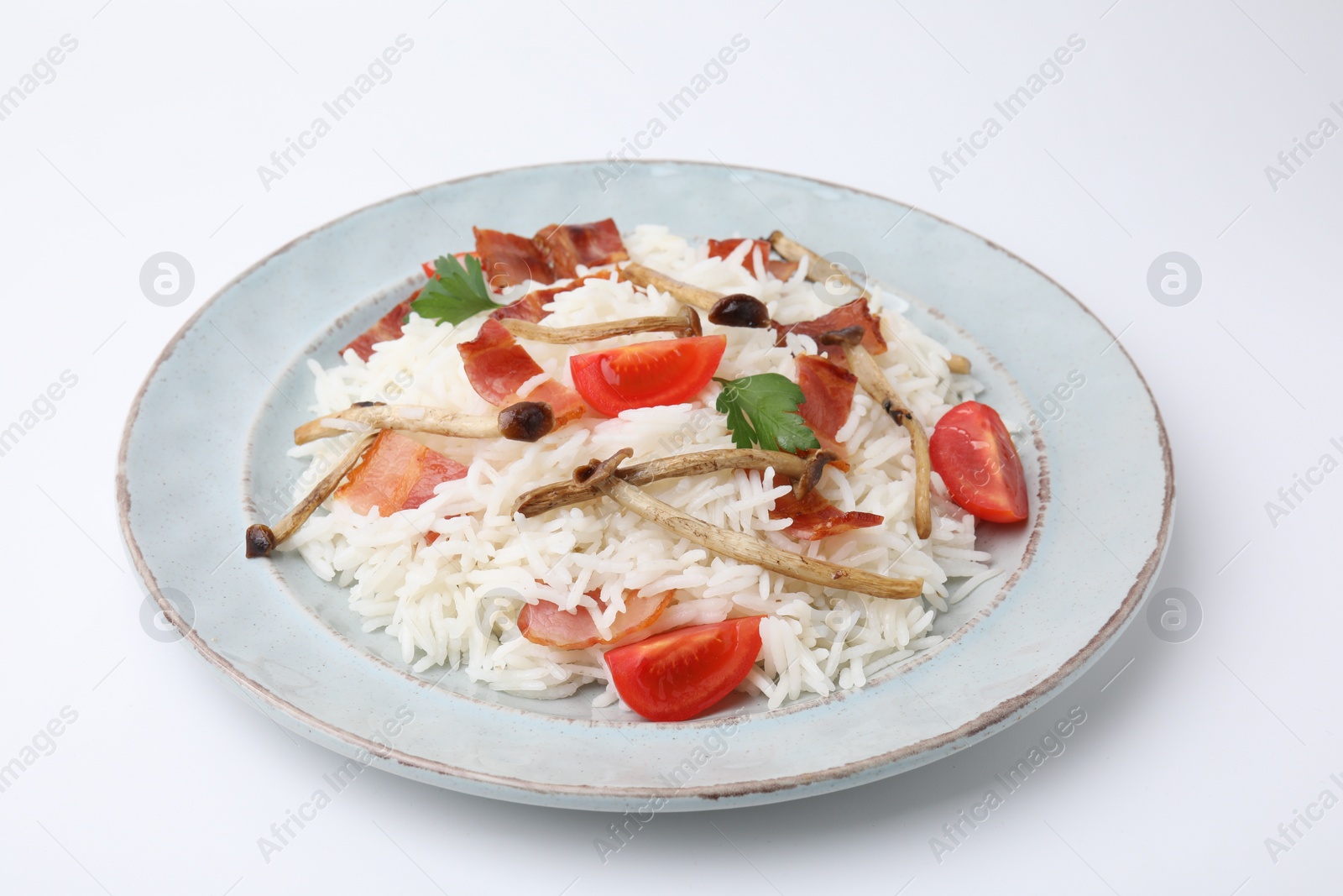 Photo of Delicious rice with bacon, mushrooms and tomatoes isolated on white