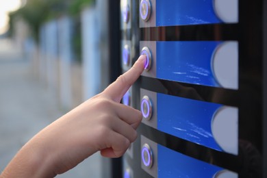 Image of Using coffee vending machine. Woman pressing button to choose drink, closeup