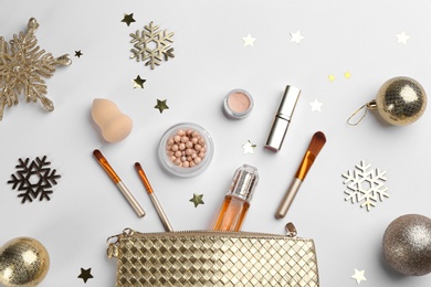 Flat lay composition with decorative cosmetic products and bag on light background. Winter care