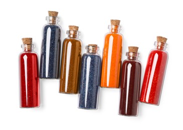 Glass bottles of different food coloring isolated on white, top view