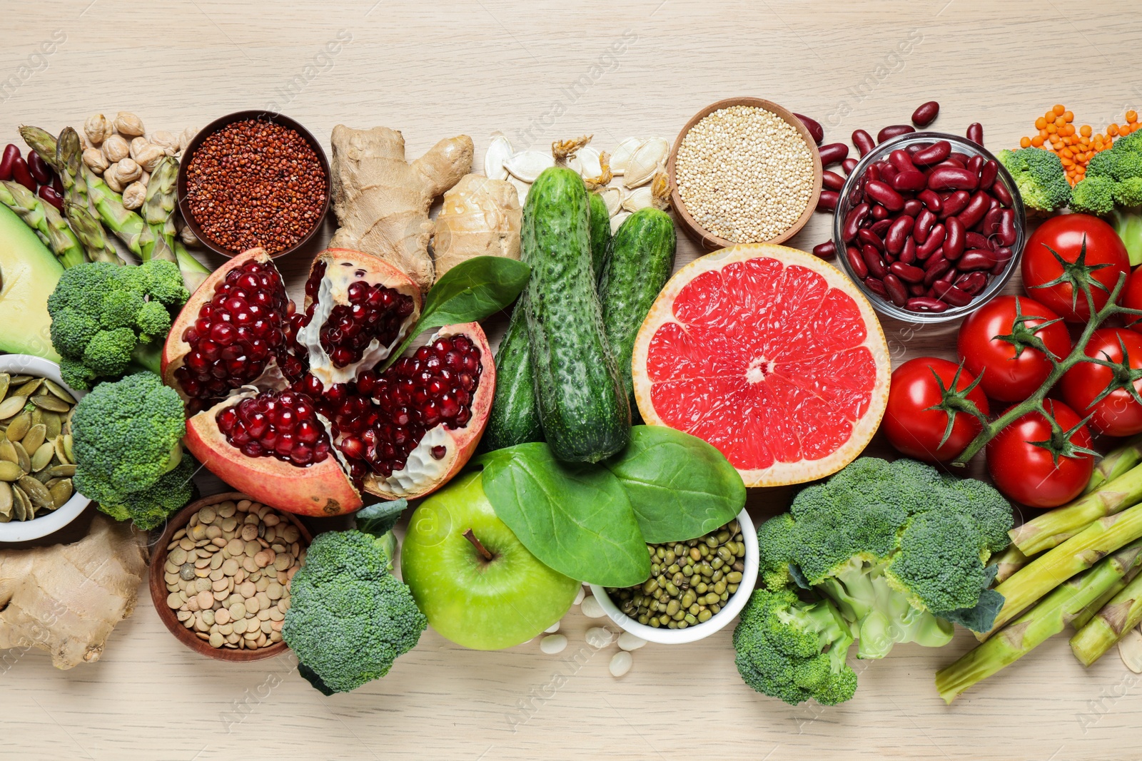 Photo of Fresh vegetables, fruits and seeds on light table, flat lay