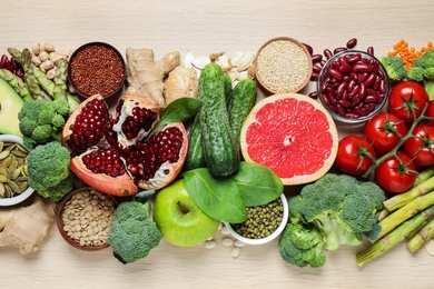 Photo of Fresh vegetables, fruits and seeds on light table, flat lay