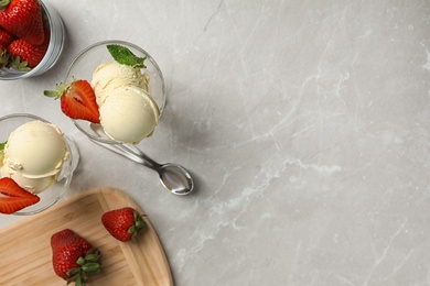 Flat lay composition with delicious vanilla ice cream and strawberries on table. Space for text