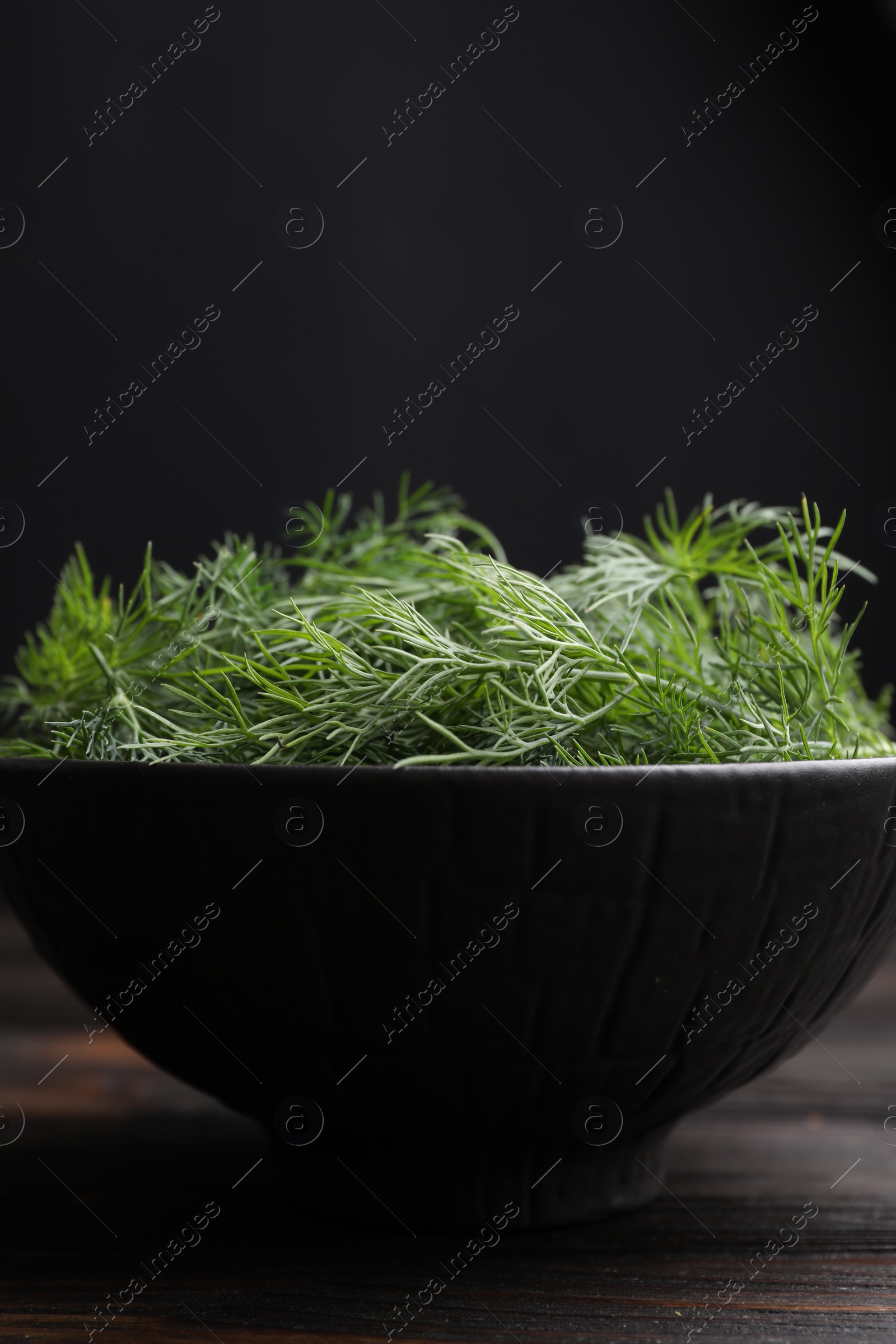 Photo of Bowl of fresh dill on table, closeup