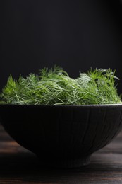 Bowl of fresh dill on table, closeup
