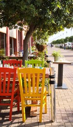 Beautiful view of outdoor cafe with colorful wooden chairs