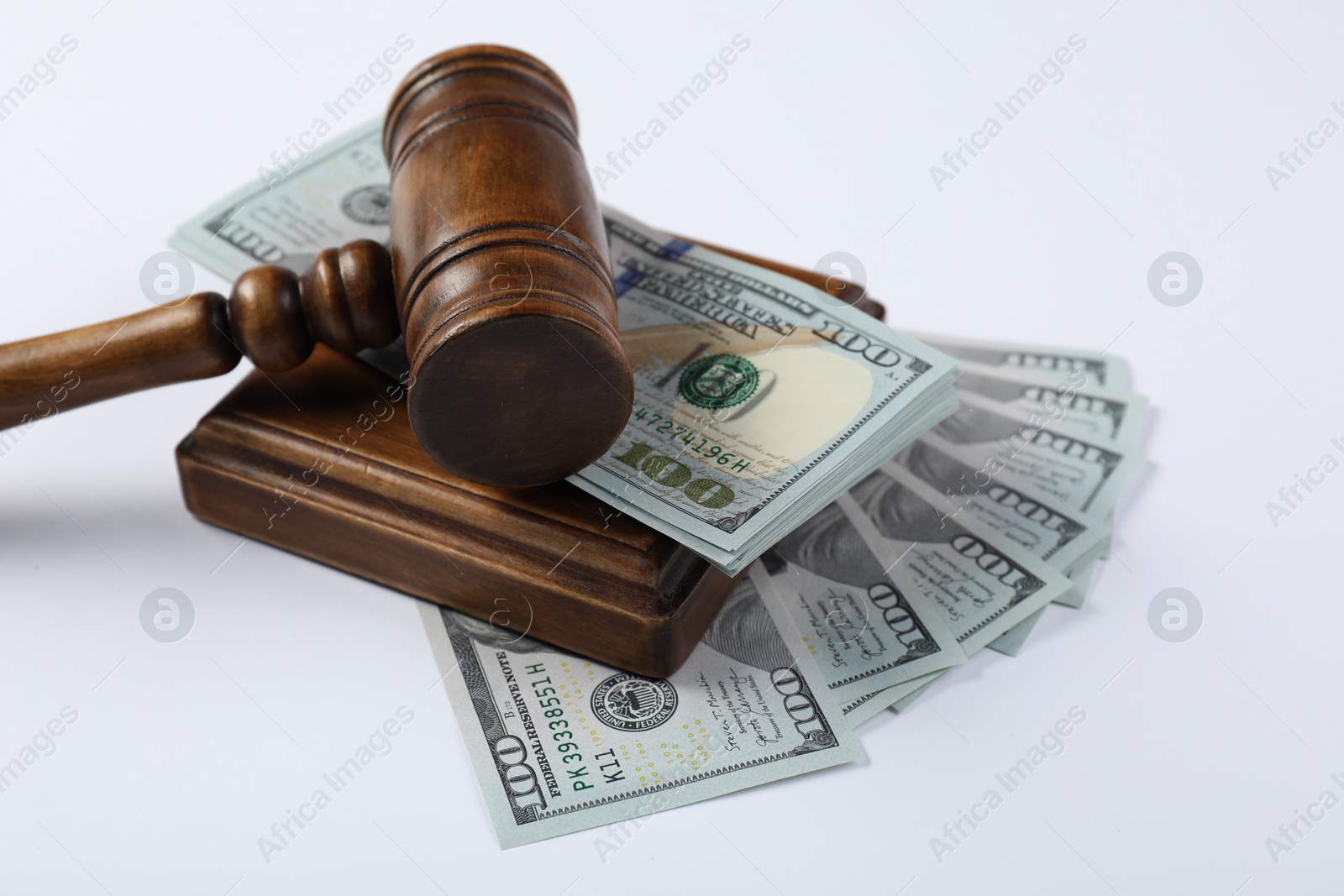 Photo of Judge's gavel and money on white background