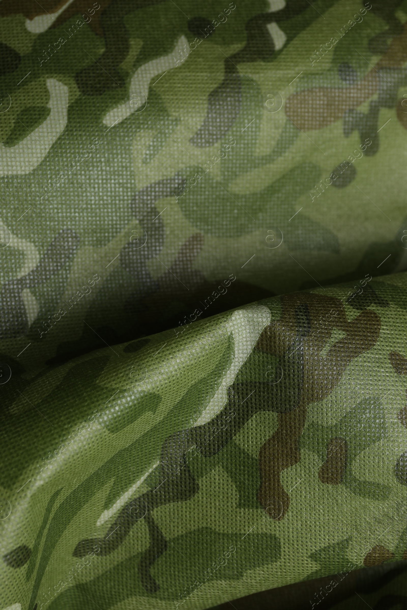 Photo of Texture of crumpled camouflage fabric as background, top view