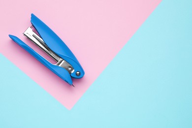 Photo of New bright stapler on color background, top view. Space for text