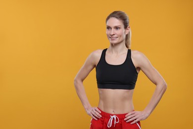 Photo of Portrait of happy sportswoman on yellow background, space for text