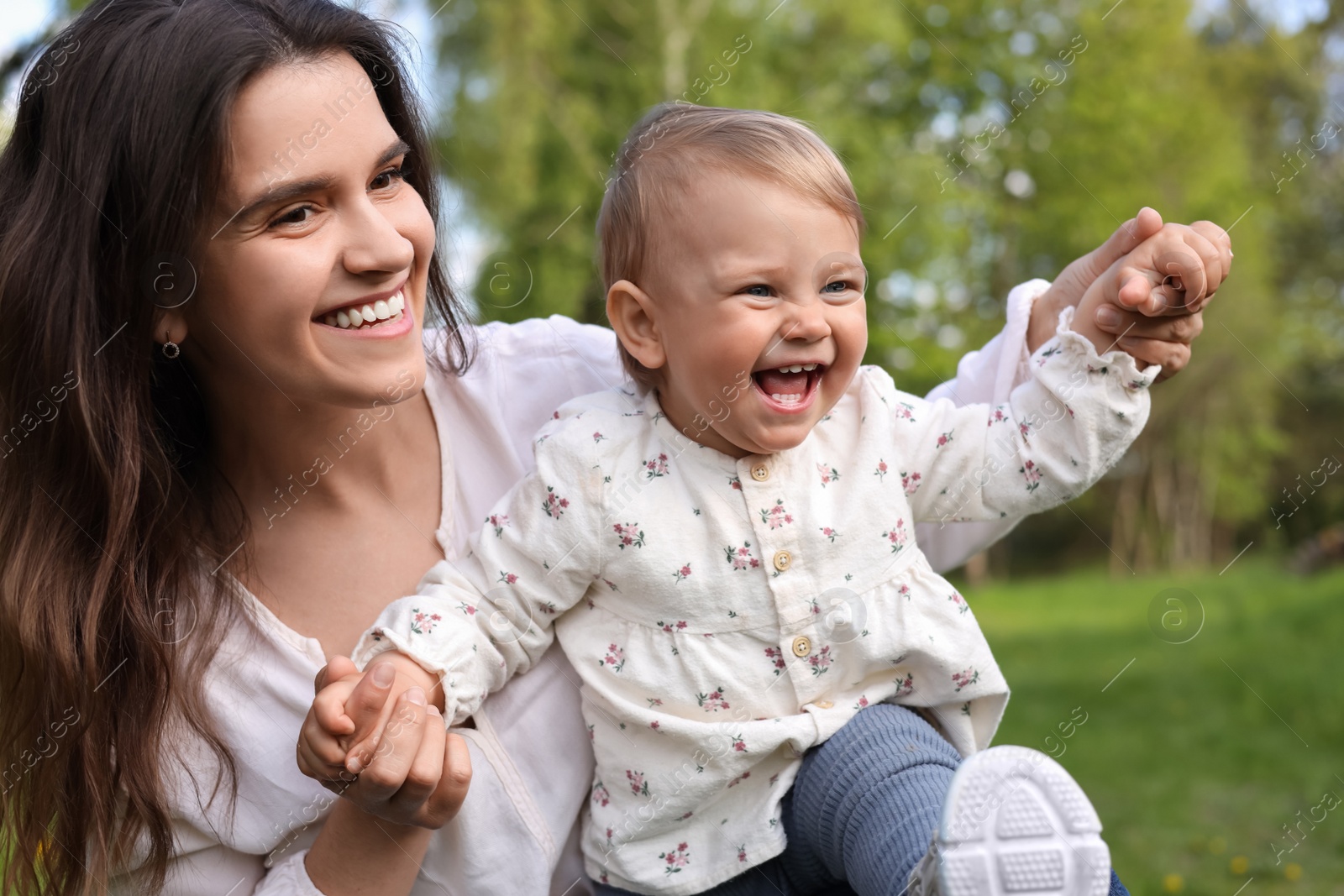 Photo of Happy mother with her cute baby in park on sunny day