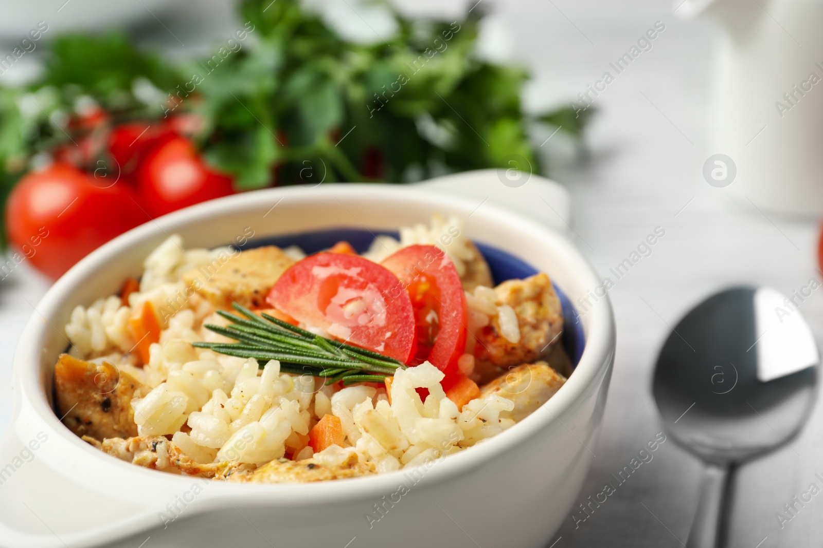 Photo of Delicious chicken risotto served in bowl, closeup