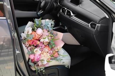 Photo of Beautiful flower bouquet inside car. Romantic surprise