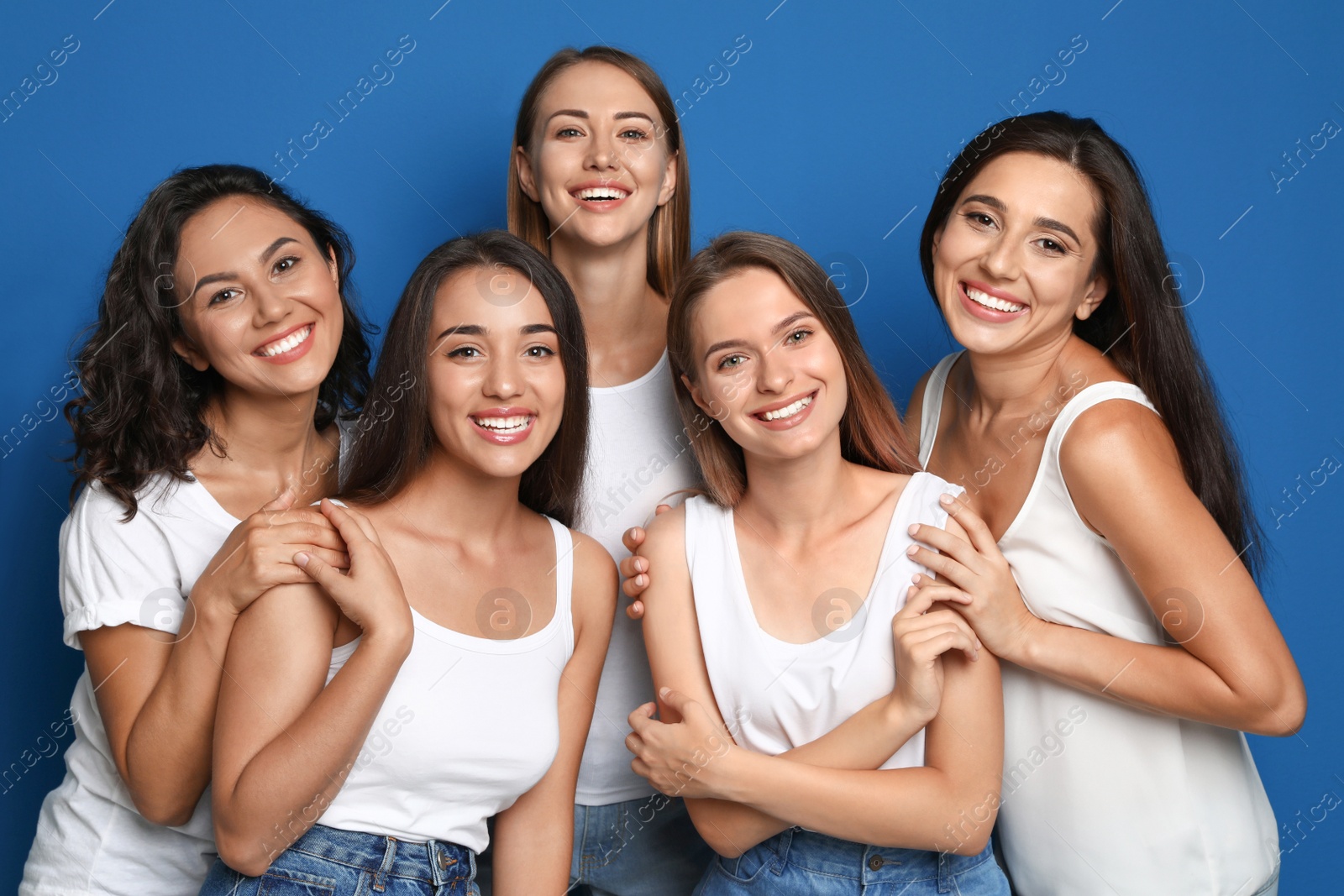 Photo of Happy women on blue background. Girl power concept