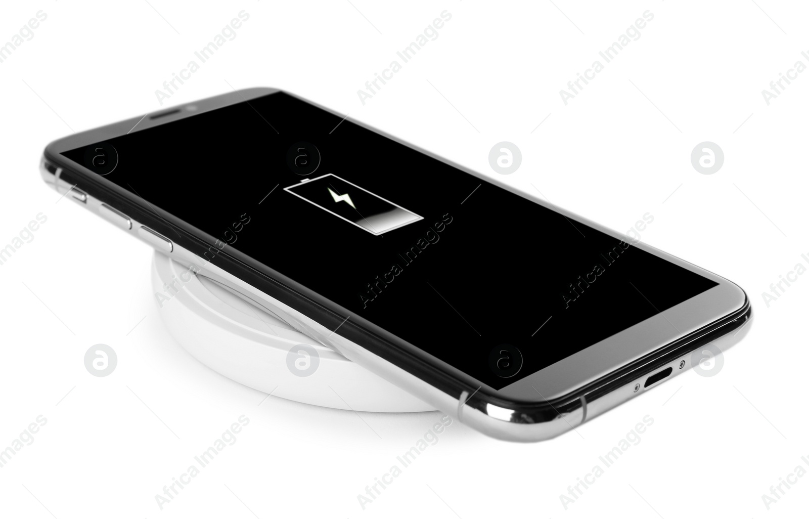 Photo of Mobile phone charging with wireless pad isolated on white