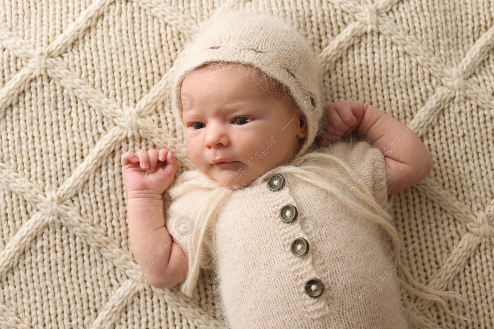 Photo of Adorable little baby lying on blanket, top view