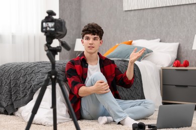 Teenage blogger explaining something while streaming at home