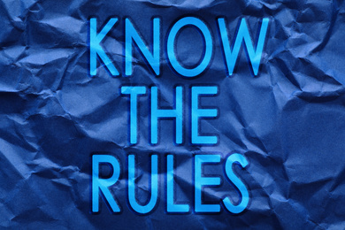 Phrase Know the rules on blue crumpled paper