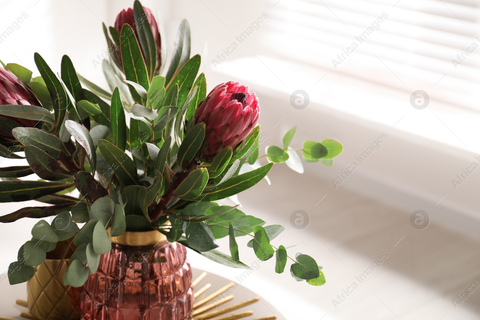 Photo of Vase with bouquet of beautiful Protea flowers on table indoors