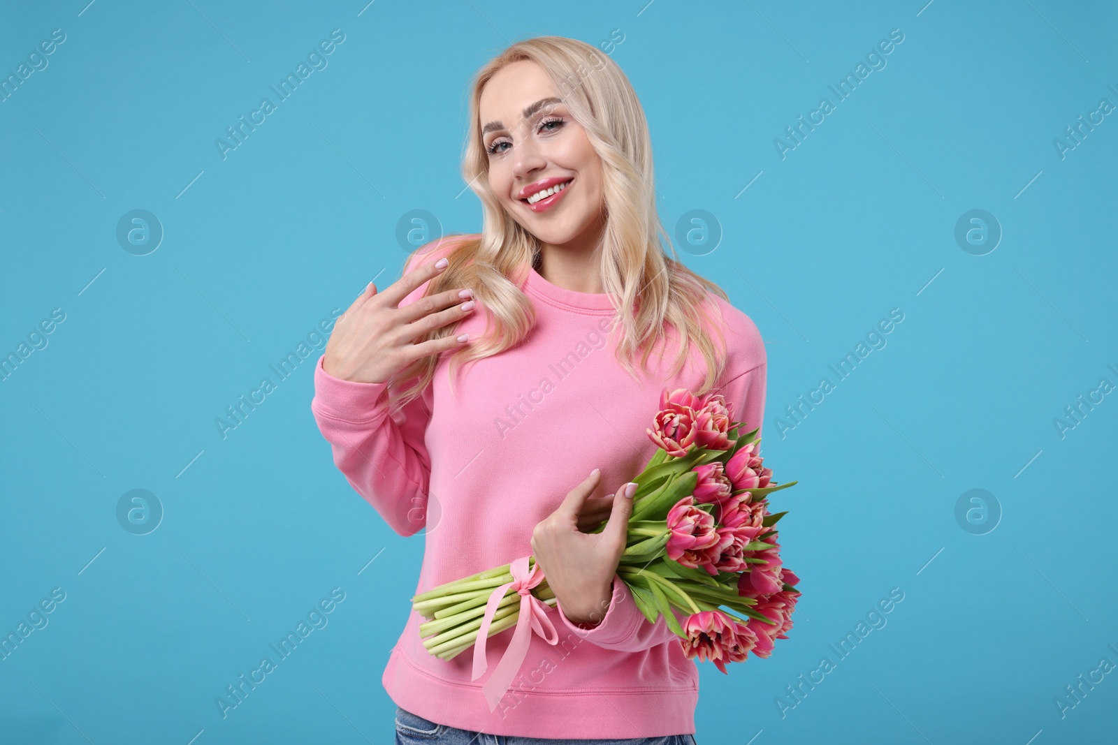 Photo of Beautiful young woman on light blue background