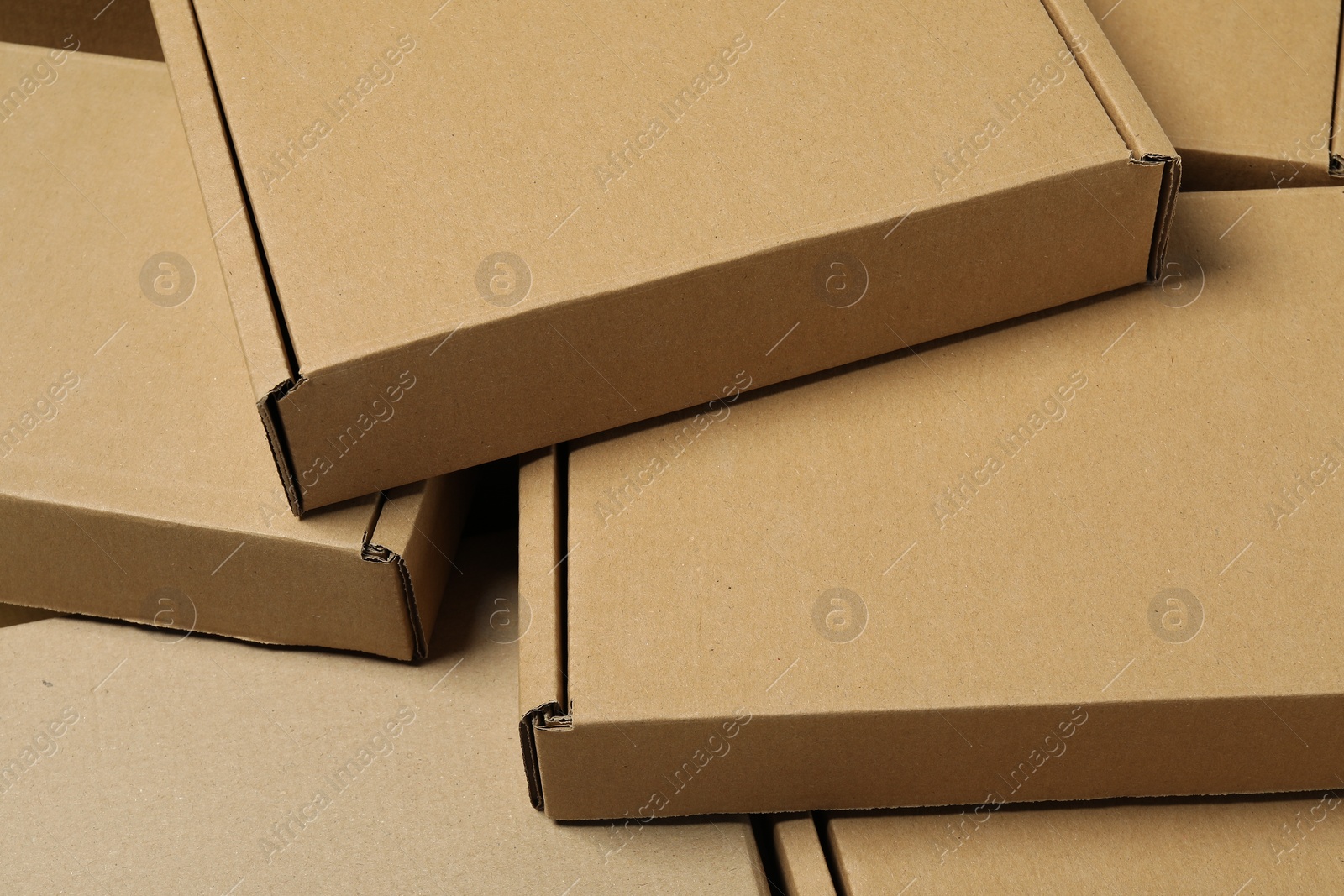 Photo of Many closed cardboard boxes as background, closeup