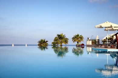 Photo of Beautiful landscape with blue sky and infinity pool at resort