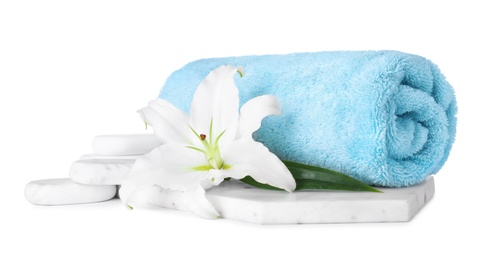 Photo of Composition with towel, spa stones and fresh flower isolated on white