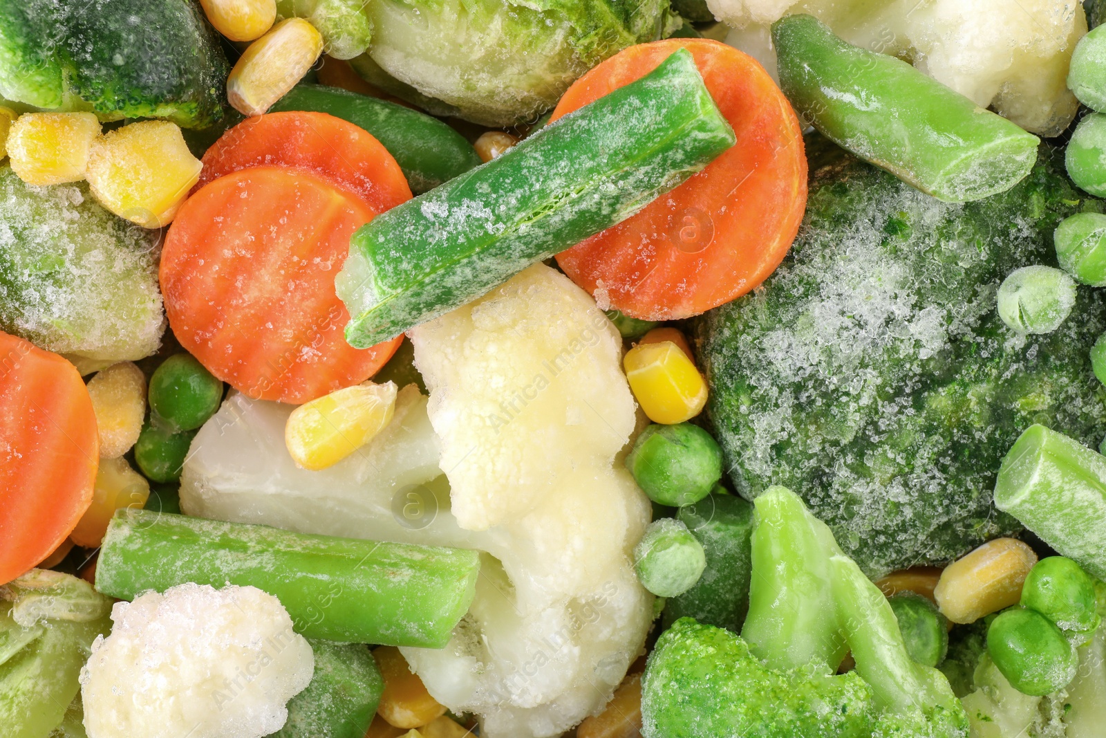 Photo of Mix of different frozen vegetables as background, top view