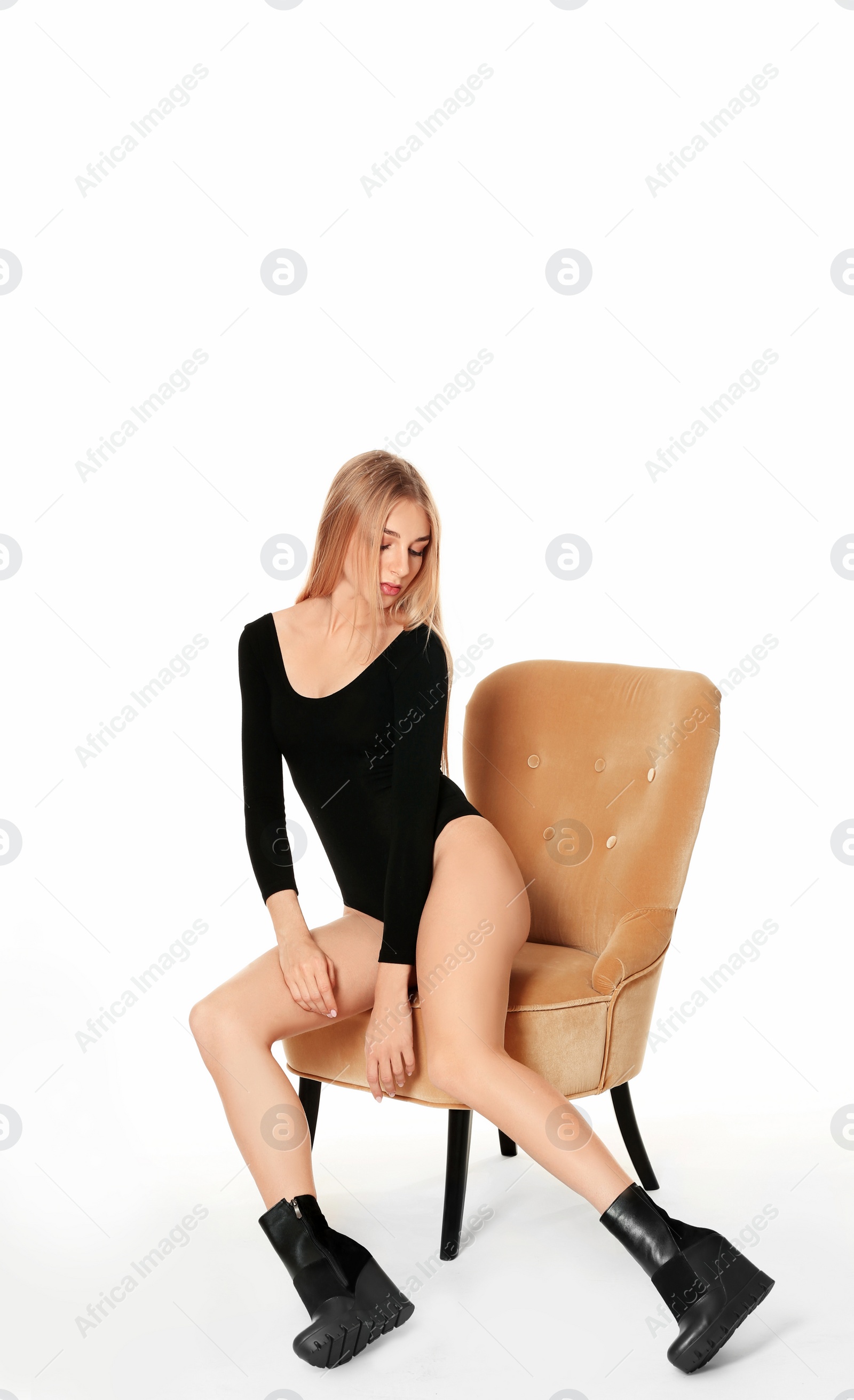 Photo of Pretty woman in stylish shoes on chair against white background