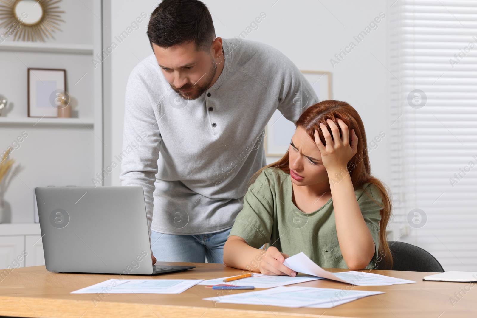 Photo of Couple doing taxes at table in room