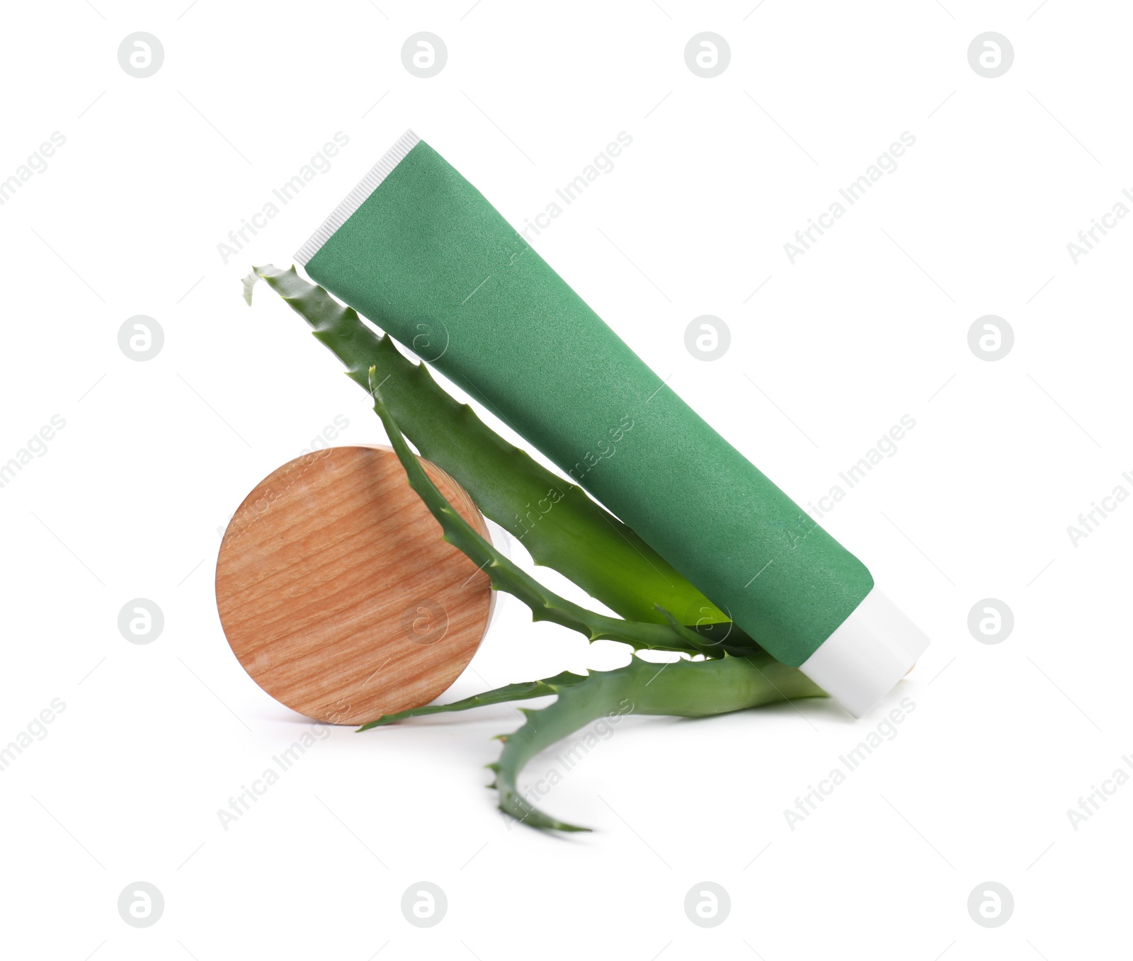 Photo of Tube of toothpaste, aloe vera leaves and wooden decor on white background