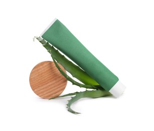 Tube of toothpaste, aloe vera leaves and wooden decor on white background